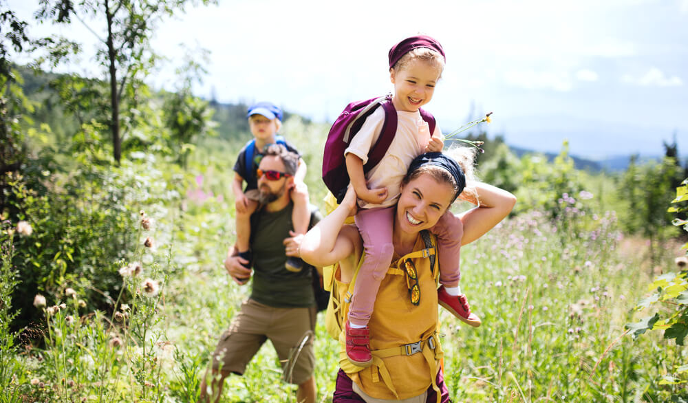 A family hiking along a trail at Schweitzer Mountain.
