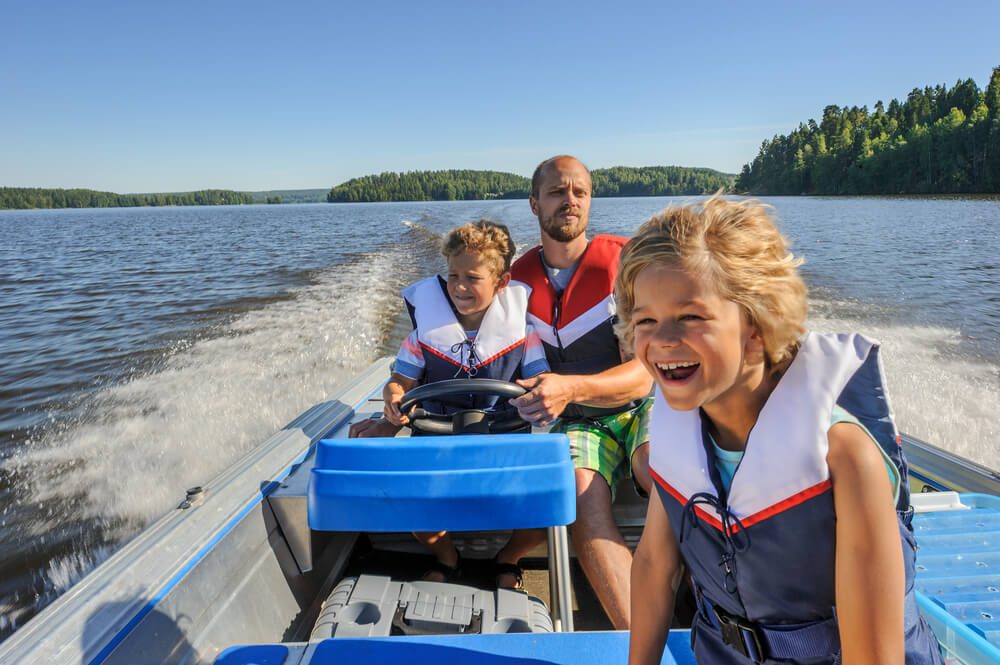 A family riding around on a boat, one of the many fun things to do in Idaho with family.